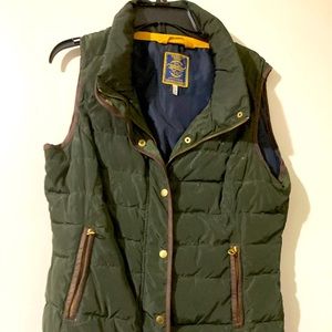 Army green vest with gold zippers.